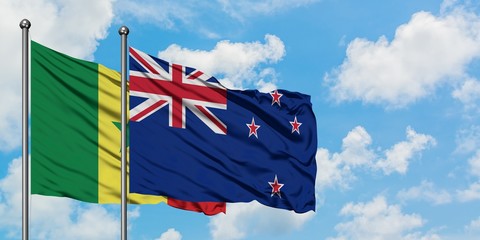 Senegal and New Zealand flag waving in the wind against white cloudy blue sky together. Diplomacy...