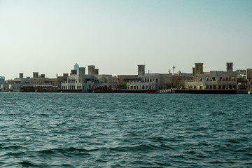 Obraz premium View from the marina to the blue water canal in the city center and buildings on the opposite bank. Dubai Bay in Deira.