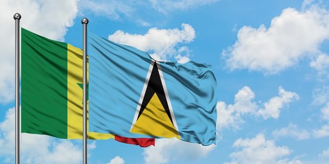 Senegal and Saint Lucia flag waving in the wind against white cloudy blue sky together. Diplomacy concept, international relations.