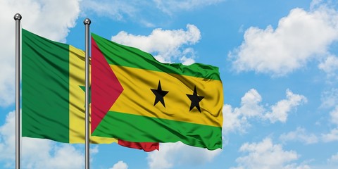 Senegal and Sao Tome And Principe flag waving in the wind against white cloudy blue sky together. Diplomacy concept, international relations.