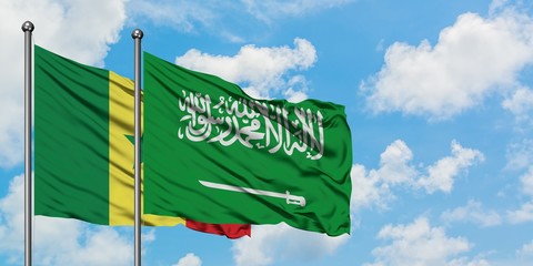 Senegal and Saudi Arabia flag waving in the wind against white cloudy blue sky together. Diplomacy concept, international relations.