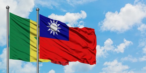 Senegal and Taiwan flag waving in the wind against white cloudy blue sky together. Diplomacy concept, international relations.