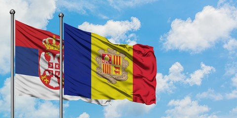 Serbia and Andorra flag waving in the wind against white cloudy blue sky together. Diplomacy...