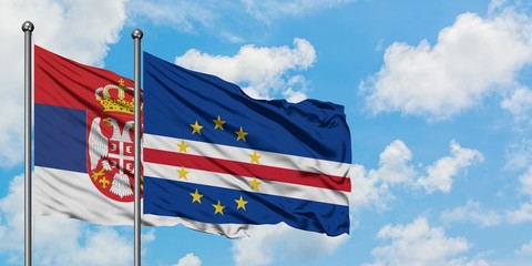 Serbia and Cape Verde flag waving in the wind against white cloudy blue sky together. Diplomacy...