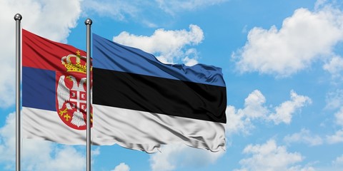 Serbia and Estonia flag waving in the wind against white cloudy blue sky together. Diplomacy concept, international relations.