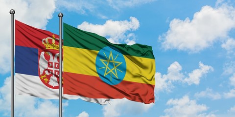 Serbia and Ethiopia flag waving in the wind against white cloudy blue sky together. Diplomacy concept, international relations.