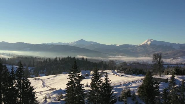 Aerial drone flight over snowy foggy scenery at Carpathian mountains, Ukraine, 4k