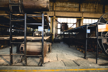 Rusty mechanisms and tools in the shop of an old abandoned factory.