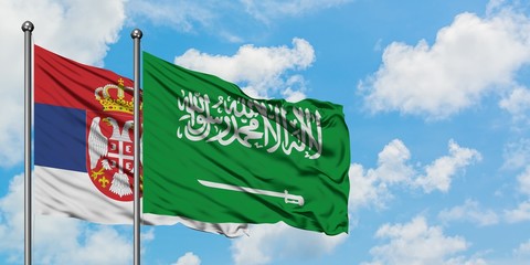 Serbia and Saudi Arabia flag waving in the wind against white cloudy blue sky together. Diplomacy...