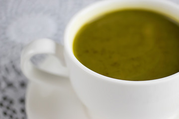 Matcha latte in a white cup. Superfood concept.