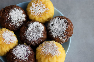 Useful buckwheat, rice and corn muffins with lemon and chocolate on a blue plate.