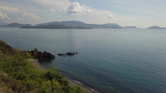 A flying camera captures a sea wave on a sandy beach in Vietnam.