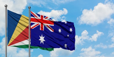 Seychelles and Australia flag waving in the wind against white cloudy blue sky together. Diplomacy concept, international relations.