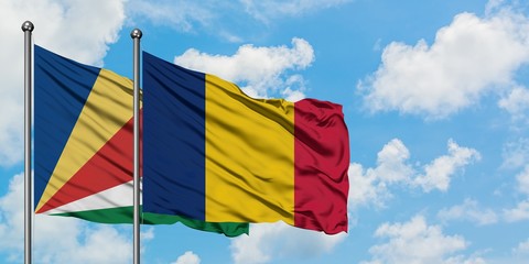 Seychelles and Chad flag waving in the wind against white cloudy blue sky together. Diplomacy concept, international relations.