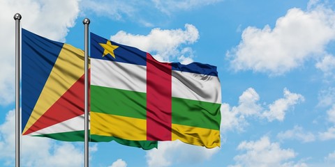 Seychelles and Central African Republic flag waving in the wind against white cloudy blue sky together. Diplomacy concept, international relations.