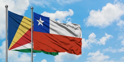 Seychelles and Chile flag waving in the wind against white cloudy blue sky together. Diplomacy concept, international relations.