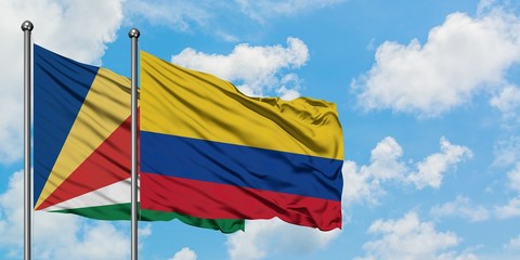 Seychelles and Colombia flag waving in the wind against white cloudy blue sky together. Diplomacy concept, international relations.