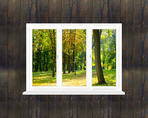 panoramic window in room with view to autumnal park