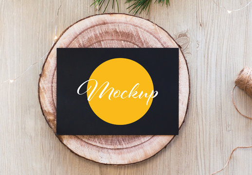 Horizontal Black Postcard on Wood Slice Top View Mockup