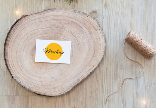 Horizontal White Business Card on Wood Slice Top View Mockup