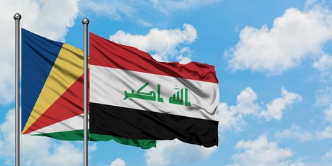Seychelles and Iraq flag waving in the wind against white cloudy blue sky together. Diplomacy...