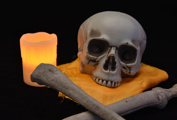caravel with candle light and two tibias in front like pirate flags