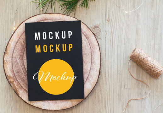 Vertical Black Postcard on Wood Slice Top View Mockup