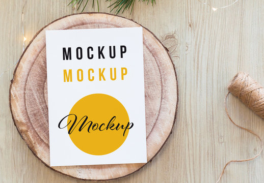 Vertical White Postcard on Wood Slice Top View Mockup