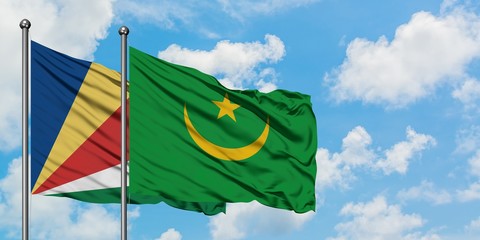 Seychelles and Mauritania flag waving in the wind against white cloudy blue sky together. Diplomacy concept, international relations.