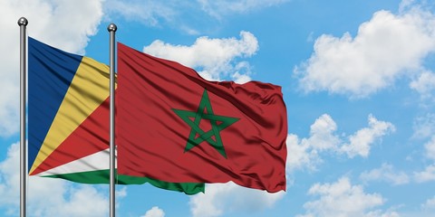 Seychelles and Morocco flag waving in the wind against white cloudy blue sky together. Diplomacy concept, international relations.