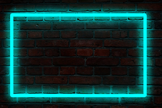 blue neon light on a brick wall at night