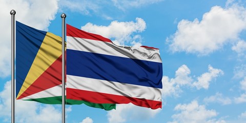 Seychelles and Thailand flag waving in the wind against white cloudy blue sky together. Diplomacy concept, international relations.