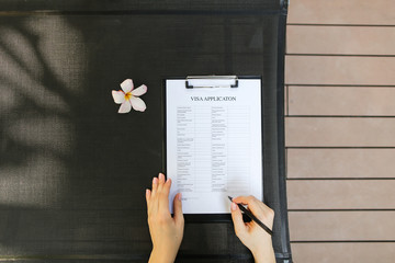 beautiful portrait of woman hands and new visa application form