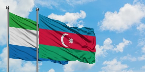 Sierra Leone and Azerbaijan flag waving in the wind against white cloudy blue sky together. Diplomacy concept, international relations.