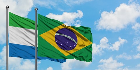Sierra Leone and Brazil flag waving in the wind against white cloudy blue sky together. Diplomacy concept, international relations.