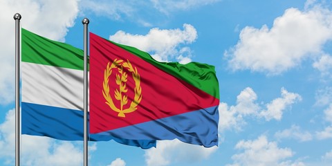 Sierra Leone and Eritrea flag waving in the wind against white cloudy blue sky together. Diplomacy concept, international relations.