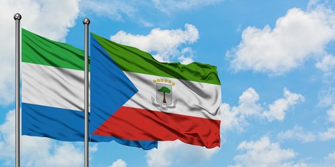 Sierra Leone and Equatorial Guinea flag waving in the wind against white cloudy blue sky together. Diplomacy concept, international relations.