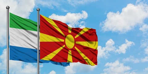 Sierra Leone and Macedonia flag waving in the wind against white cloudy blue sky together. Diplomacy concept, international relations.