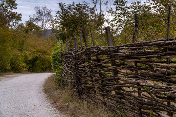 Fototapeta na wymiar Picturesque wicker village fence in the valley of the Zhane river near Gelendzhik.