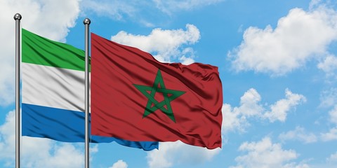 Sierra Leone and Morocco flag waving in the wind against white cloudy blue sky together. Diplomacy concept, international relations.