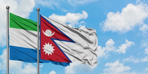 Sierra Leone and Nepal flag waving in the wind against white cloudy blue sky together. Diplomacy concept, international relations.