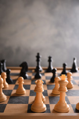 Chess board with chess, black and white on a gray background