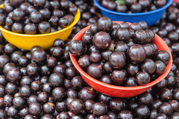 Baskets with jabuticaba. Street market with Brazilian fruit.