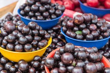 Baskets with jabuticaba. Street market with Brazilian fruit.