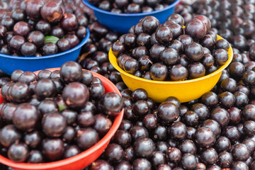 Baskets with jabuticaba. Street market with Brazilian fruit.