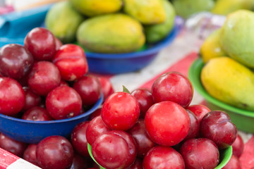 Plums and mangoes piled at the street market