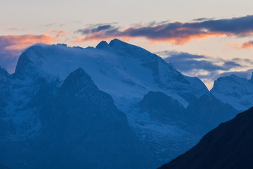 Fototapeta na wymiar Alpenglow and clouds highlighting Marmolada, Cortina d'Ampezzo, Dolomites, Veneto, Italy