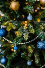Dressed up Christmas tree. Gold and blue Christmas tree decorations for Christmas.
