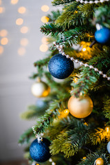 Dressed up Christmas tree. Gold and blue Christmas tree decorations for Christmas.