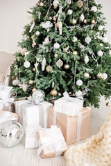 Christmas festive tree with many gifts under it from Santa Claus